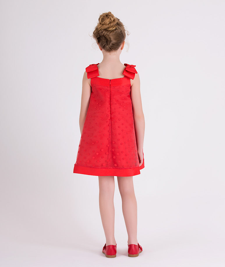 red dress with little polka dots and bows on the shoulders