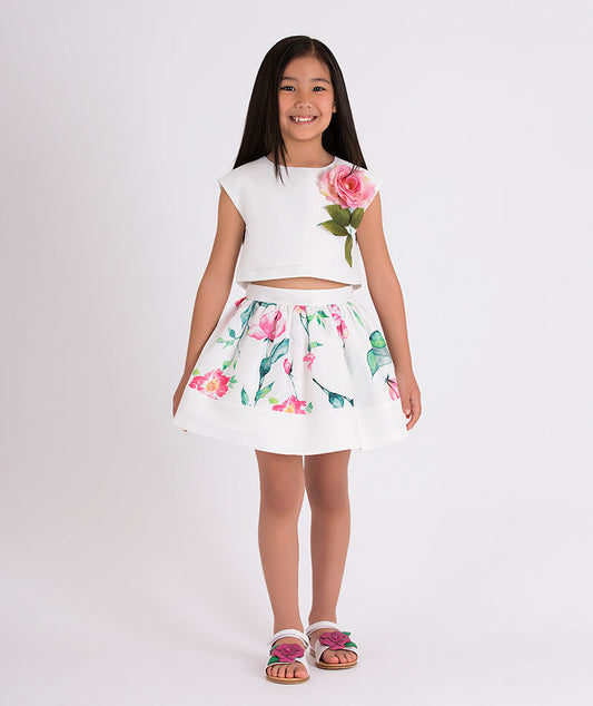 white blouse with 3D flower applique on the front and floral skirt