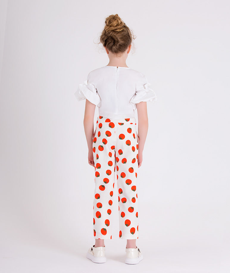 white blouse with ruffled sleeves and pants with tomato prints