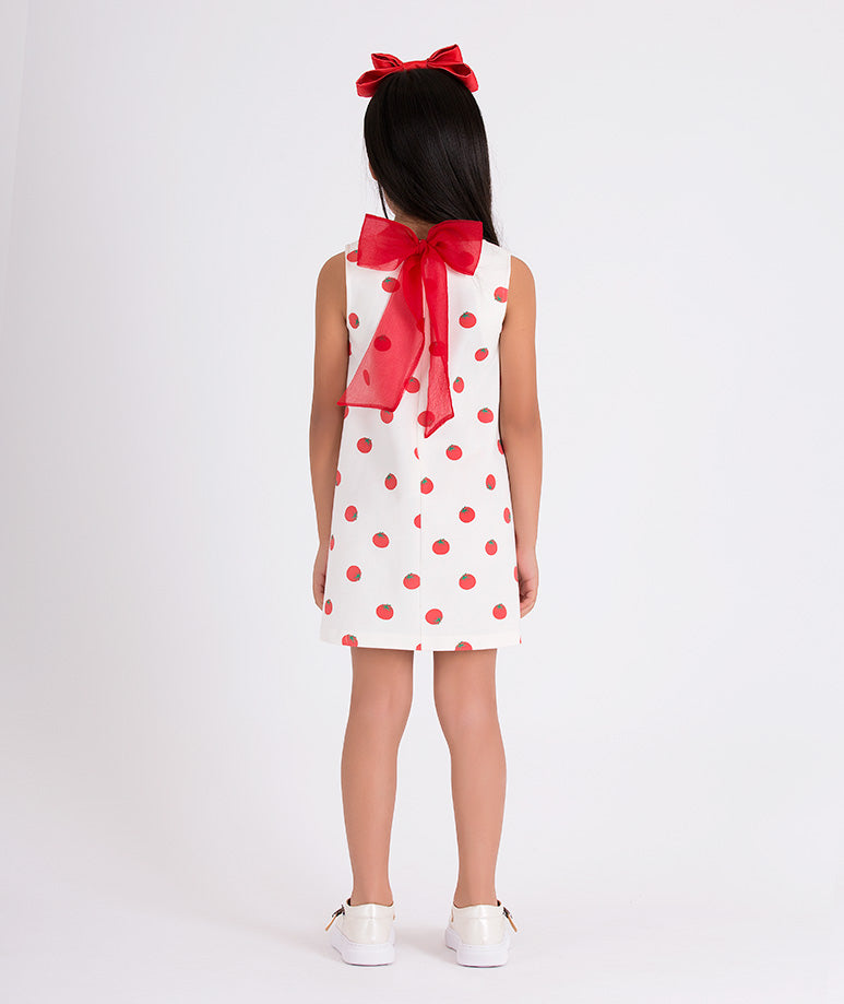 ecru dress with tomato prints and a big organza red bow on the back
