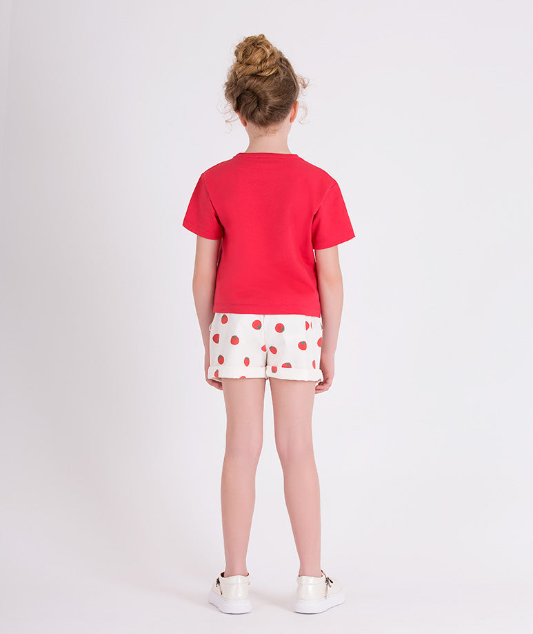 red t-shirt and ecru shorts with tomato prints