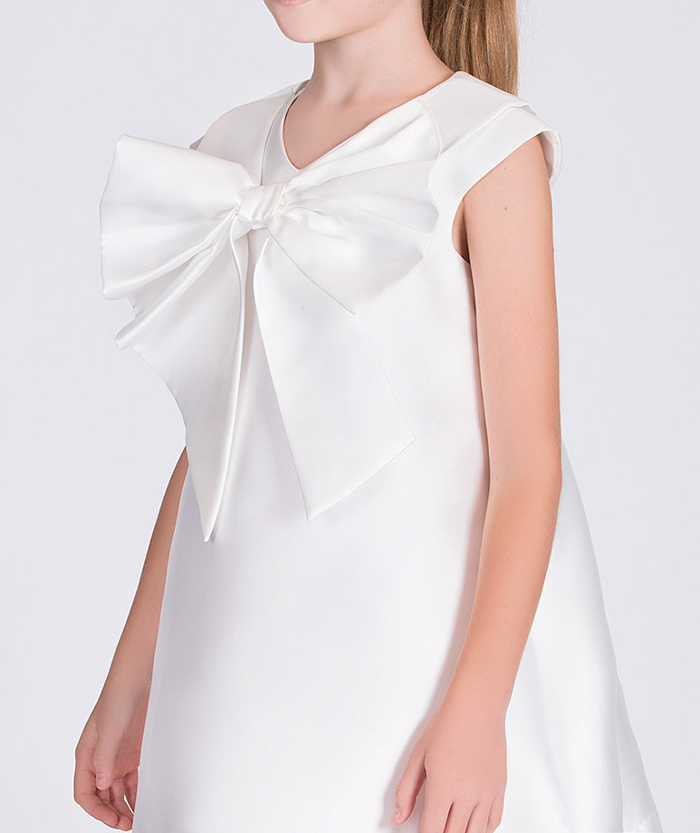 white dress with a big bow on the front