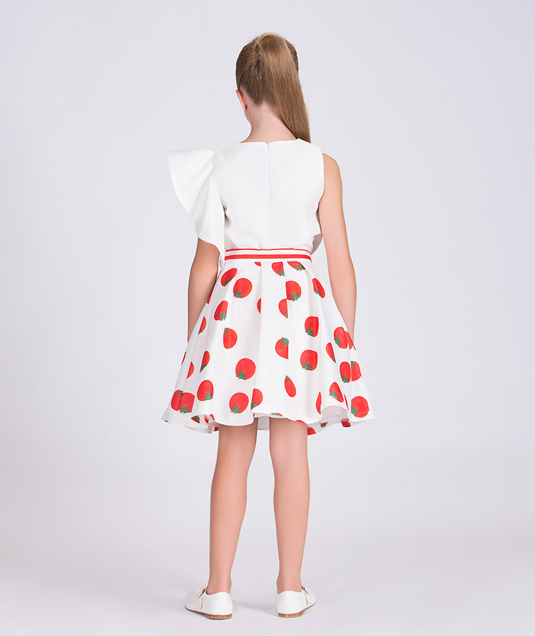 ecru blouse with one ruffled sleeve and ecru skirt with tomato prints