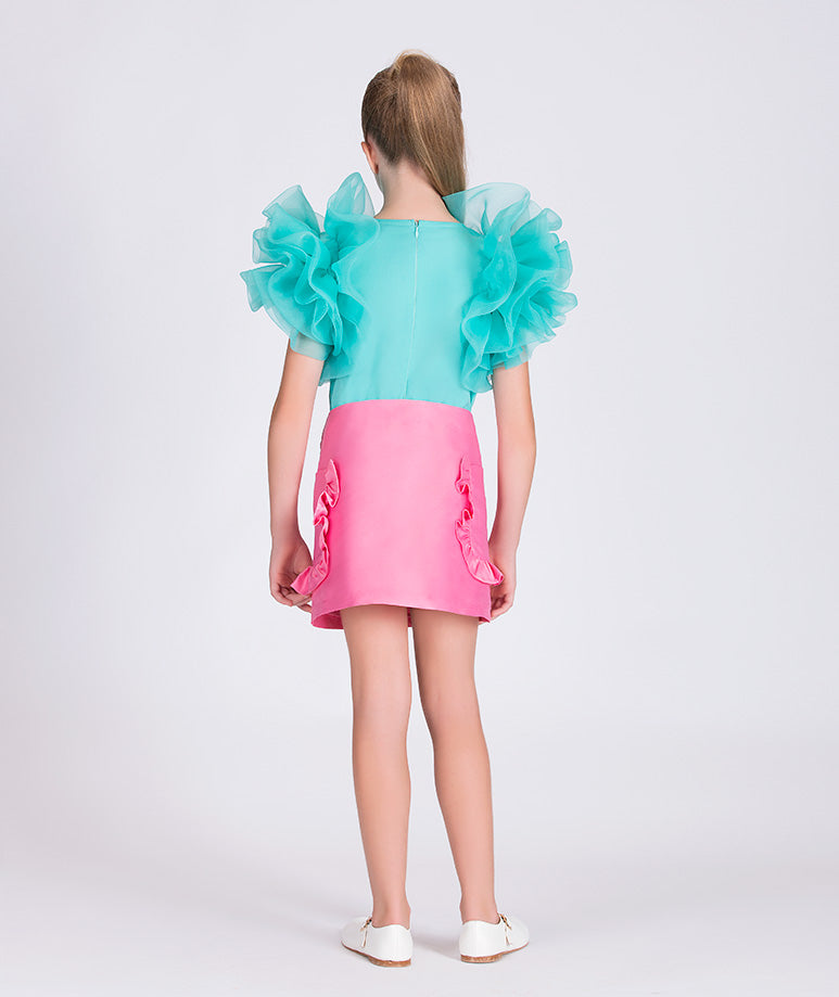 mint blouse with ruffled sleeves and pink skirt with ruffled pockets