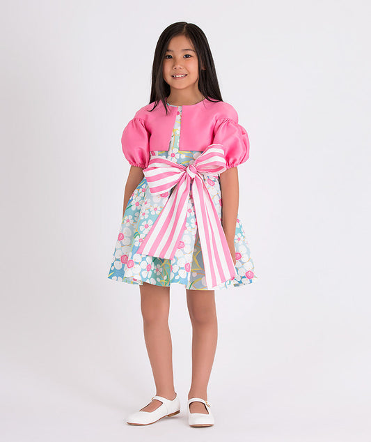 pink balloon sleeved bolero and a blue floral dress with a pink and white striped bow on the waist