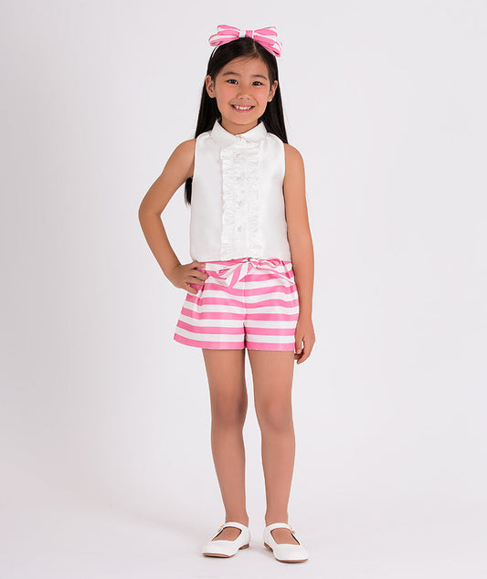 ecru blouse with ruffled front, pink and white striped shorts with a bow on the waist