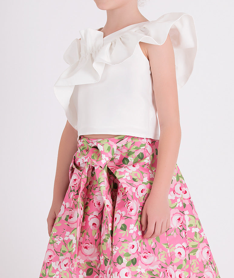 white one shoulder ruffled blouse and pink floral skirt