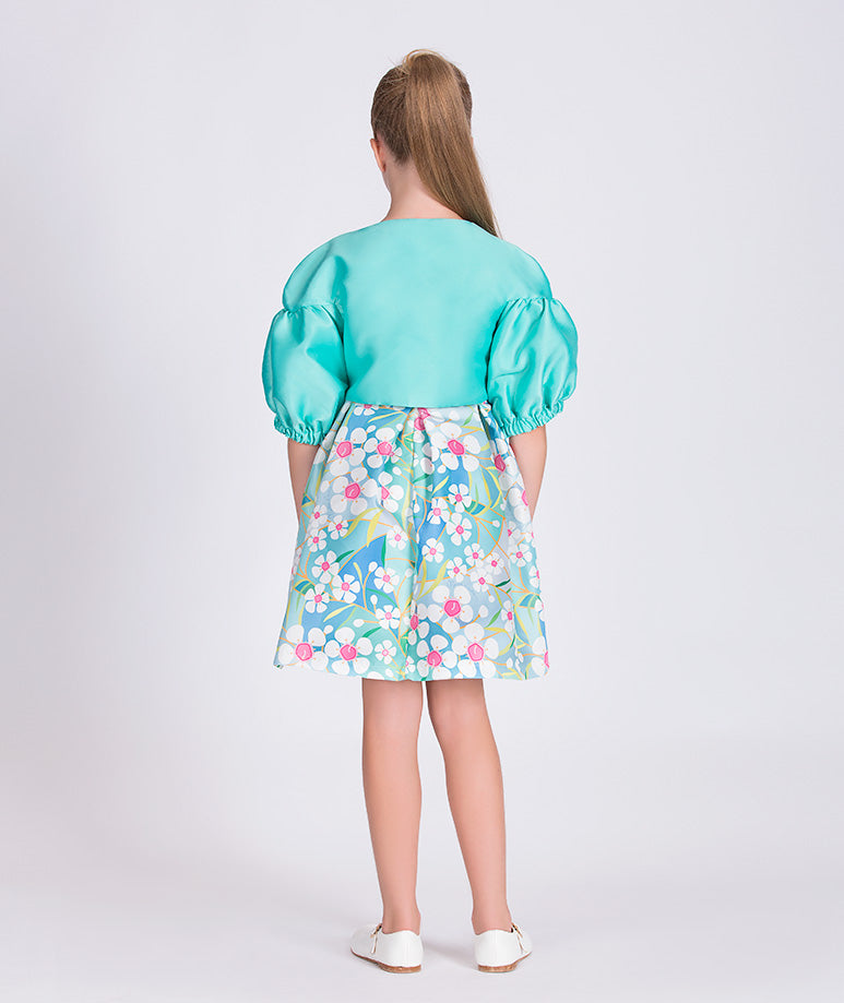 mint jacket with balloon sleeves and a blue floral dress