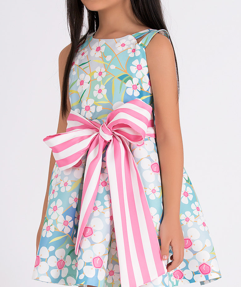 blue floral summer dress with a big, pink and white striped bow on the waist
